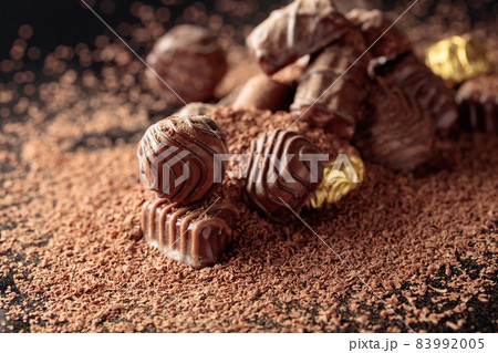 Chocolate candies sprinkled with chocolate chips. 83992005