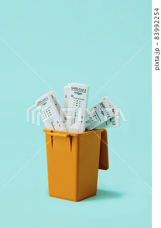 used covid-19 rapid test devices in the dustbin 83992254