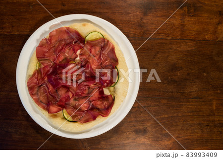 Italian pizza with bresaola, zucchini and eggplant Italian pizza with bresaola, zucchini and eggplant 83993409