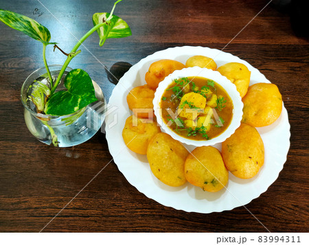 Jharkhand's famous snack Dhuska with potato curry 83994311