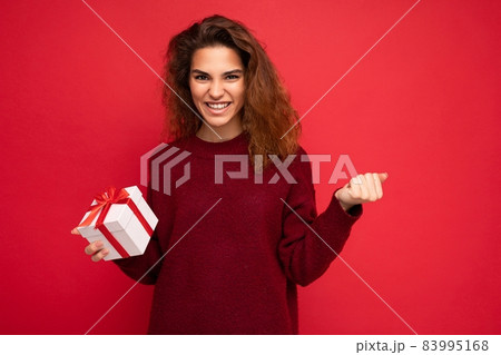 Photo of beautiful attractive charming positive happy funny young brunette curly woman wearing Photo of beautiful attractive charming positive happy funny young brunette curly woman wearing 83995168