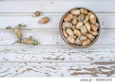 hazelnuts in a bowl on a wooden table 83995245