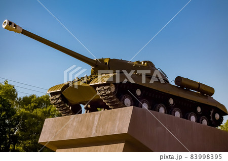 Military monument - an old tank on a pedestal. Symbol of Victory Day - military tank on a pedestal Military monument - an old tank on a pedestal. Symbol of Victory Day - military tank on a pedestal 83998395