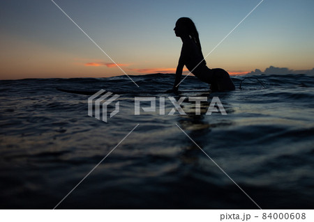 beautiful girl with a surfboard at sunset. beautiful girl with a surfboard at sunset. 84000608