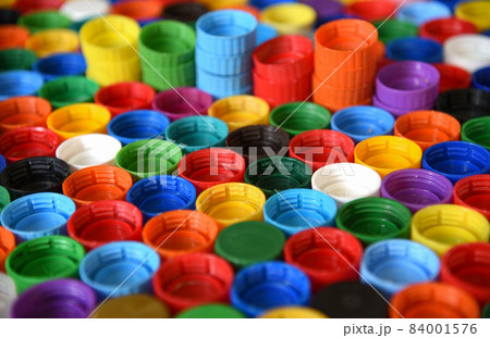 Plastic bottle caps background. Cap material is recyclable. 84001576