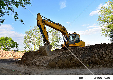 Excavator on earthworks at construction site. Excavator on earthworks at construction site. 84001586