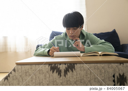 こたつで勉強する男子学生 こたつで勉強する男子学生 84005067
