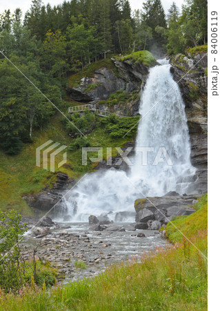 Steinsdalfossen Waterfall. Norway. Summer. Waterfall among the forest on the rocks 84006119