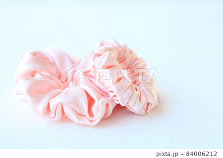 Pink silk Scrunchy isolated on white background. Flat lay Hairdressing tool of Colorful Elastic Hair Band, Bobble Scrunchie Hairband Pink silk Scrunchy isolated on white background. Flat lay Hairdressing tool of Colorful Elastic Hair Band, Bobble Scrunchie Hairband 84006212