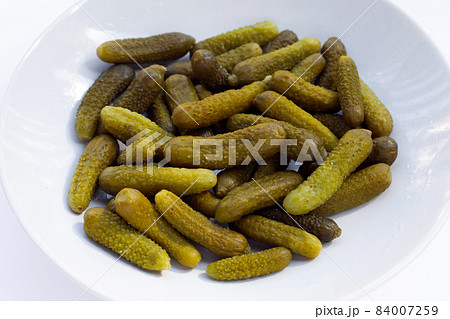 Pickled gherkins or cucumbers on white background. Pickled gherkins or cucumbers on white background. 84007259