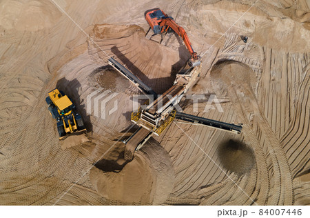 Arial view of the sand open-pit mining with heavy mining machinery 84007446