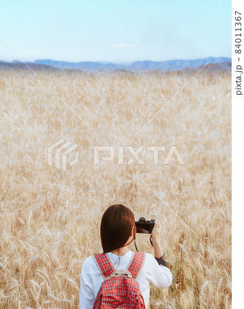 Traveler woman taking photo of wheat field in the morning natural background. Traveler woman taking photo of wheat field in the morning natural background. 84011367