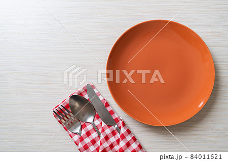 empty plate or dish with knife, fork and spoon empty plate or dish with knife, fork and spoon 84011621