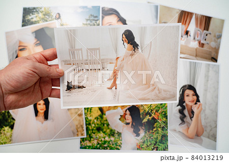printed on paper photos of a beautiful brunette bride.  84013219