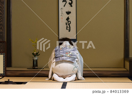 Japanese tea ceremony master during ceremonial preparation and presentation of powdered green tea matcha 84013369