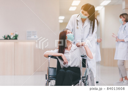 Doctor talking with woman patient and hands holding together,Follow up treatment at hospital 84013608