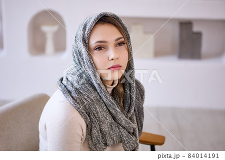 Headscarf, scarf or hijab on head of European woman. Headscarf, scarf or hijab on head of European woman. 84014191