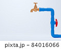 Brass faucet and blue PVC water pipe on white background. Closeup and copy space for text or article on the left. The concept of plumber maintenance work. 84016066