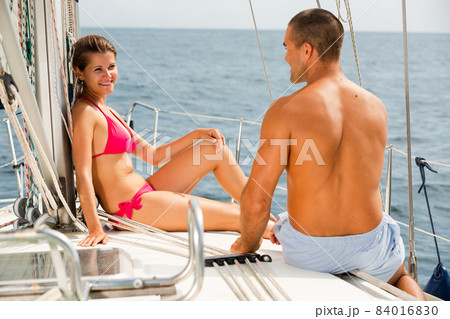 Couple talking on deck of sailboat Couple talking on deck of sailboat 84016830