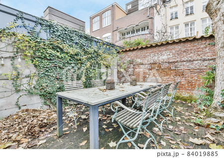 The courtyard of the house with a table and chairs 84019885