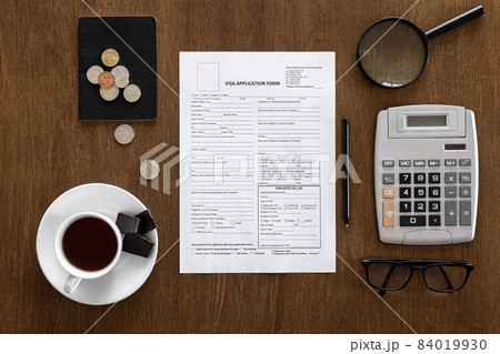 Visa application form on a wooden table, visa processing, registration, flat lay 84019930