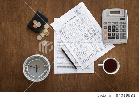 Visa application form on a wooden table, visa processing, registration, flat lay Visa application form on a wooden table, visa processing, registration, flat lay 84019931