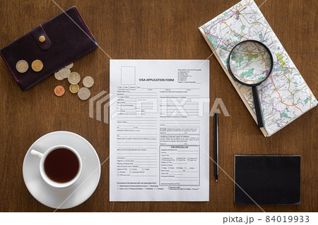 Visa application form on a wooden table, visa processing, registration, flat lay Visa application form on a wooden table, visa processing, registration, flat lay 84019933