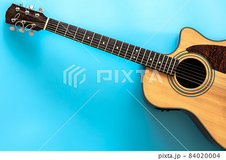 Acoustic guitar on a blue background, top view, copy space. 84020004