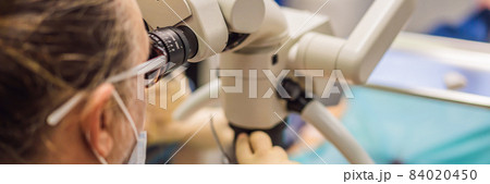 BANNER, LONG FORMAT Dental treatment with a microscope. Woman having teeth examined at dentists. Appointment at the dentist. lifestyle, real life BANNER, LONG FORMAT Dental treatment with a microscope. Woman having teeth examined at dentists. Appointment at the dentist. lifestyle, real life 84020450