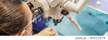 BANNER, LONG FORMAT Dental treatment with a microscope. Woman having teeth examined at dentists. Appointment at the dentist. lifestyle, real life 84022678