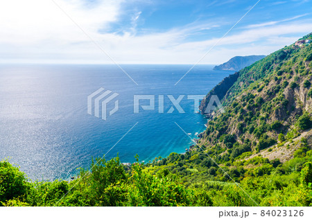 Aerial top panoramic view of green hills, rocks, cliffs and Gulf of Genoa, Ligurian Sea 84023126