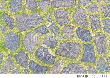Cobblestone pavement background with copy space. Abstract old close-up cobble stone texture 84023144