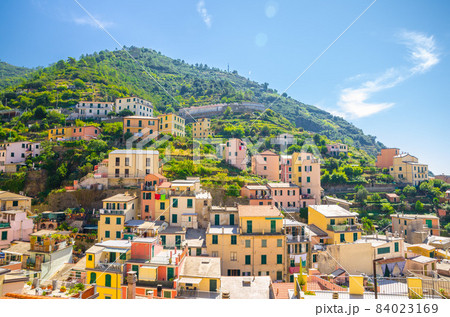 Colorful multicolored buildings houses on green hill in valley of Riomaggiore Colorful multicolored buildings houses on green hill in valley of Riomaggiore 84023169