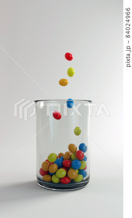3D render Colored sweets in a transparent glass on a white background 84024966