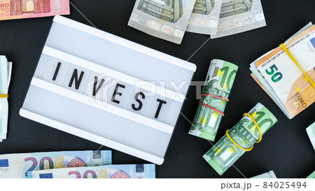 Lightbox board with word INVEST in black letters around euro banknotes. Money, Business, finance, investment, saving Lightbox board with word INVEST in black letters around euro banknotes. Money, Business, finance, investment, saving 84025494
