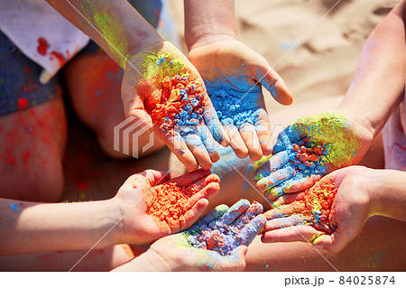 three children holding colorful powder in hands three children holding colorful powder in hands 84025874