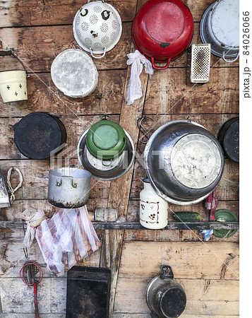 hanged saucepans on a wooden wall of a house in Romania hanged saucepans on a wooden wall of a house in Romania 84026066
