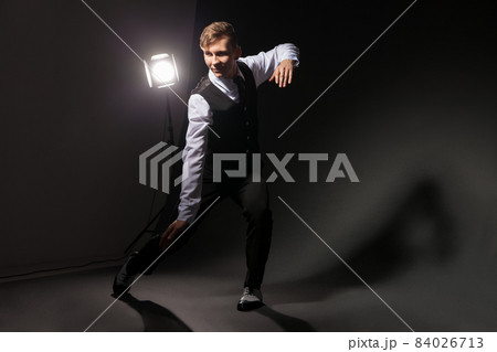 modern style dancer dancing on dark background modern style dancer dancing on dark background 84026713