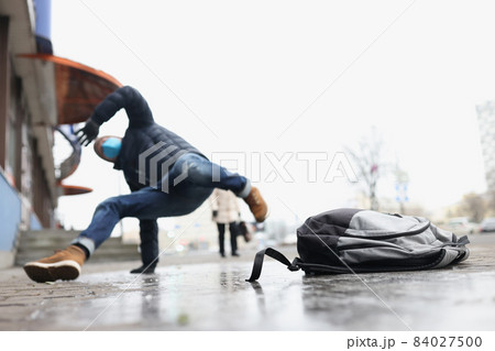 Male person get injury after falling on slippery ground in winter Male person get injury after falling on slippery ground in winter 84027500
