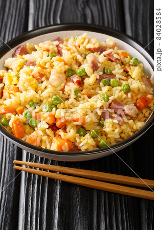 Yangzhou fried rice Traditional Chinese food close up in the plate. Vertical Yangzhou fried rice Traditional Chinese food close up in the plate. Vertical 84028584