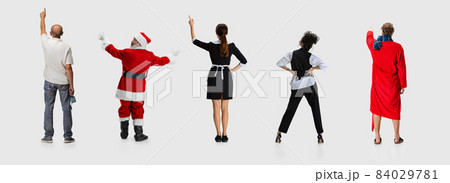 Collage of different people standing in a line and pointing somewhere isolated on white background. Back view 84029781