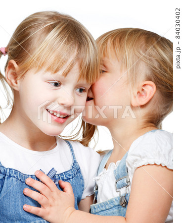 Little girls sharing a secret 84030402