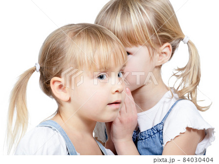 Little girls sharing a secret 84030404