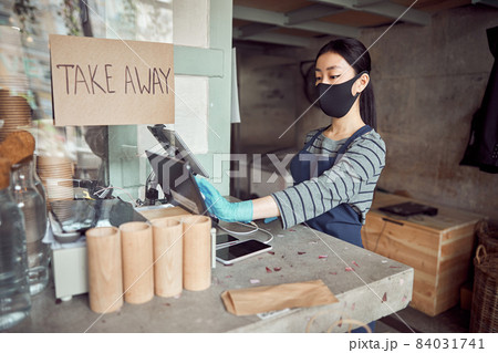 Barista in protective mask working in cafe Barista in protective mask working in cafe 84031741