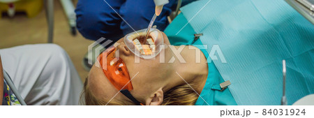 BANNER, LONG FORMAT Woman having teeth examined at dentists. Dental treatment in dentistry. Appointment at the dentist. lifestyle, real life 84031924