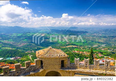 Aerial top panoramic view landscape with valley, green hills, fields, villages of Republic San Marino 84032382
