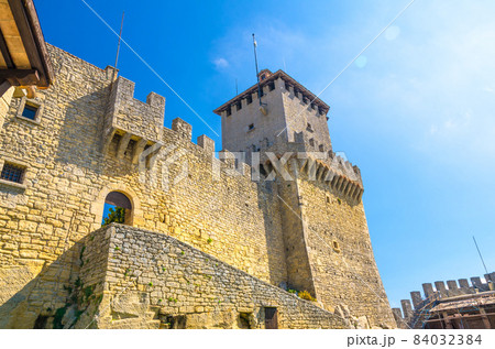 Prima Torre Guaita first medieval tower with stone brick fortress wall with merlons on Mount Titano rock 84032384
