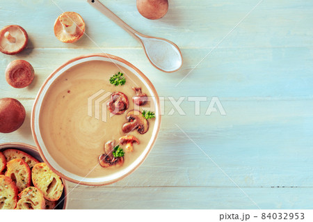 Mushroom soup with various mushrooms and toasted bread, overhead shot Mushroom soup with various mushrooms and toasted bread, overhead shot 84032953