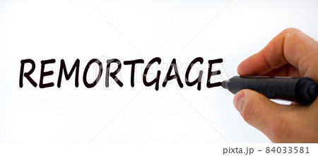 Remortgage symbol. Businessman writing the word 'remortgage', isolated on beautiful white background. Business and remortgage concept, copy space. Remortgage symbol. Businessman writing the word 'remortgage', isolated on beautiful white background. Business and remortgage concept, copy space. 84033581