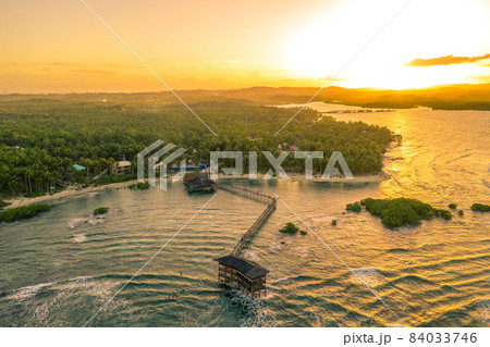 Sunset at Cloud Nine Surfing Area, Siargao Island, Philippines. Aerial Drone shot. Sunset at Cloud Nine Surfing Area, Siargao Island, Philippines. Aerial Drone shot. 84033746